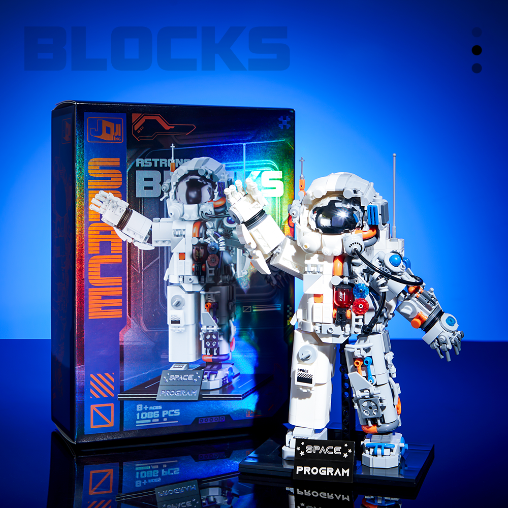 Mechanical astronaut model displayed beside its illustrated product box.