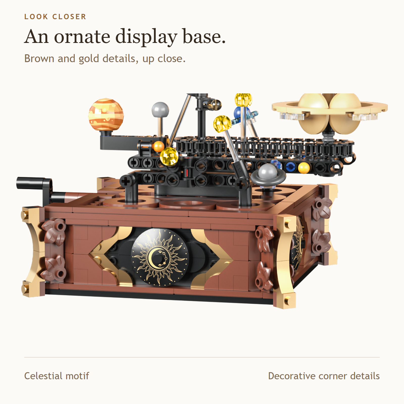 Close-up of the included brown display base, its gold celestial motif and decorative corner details.