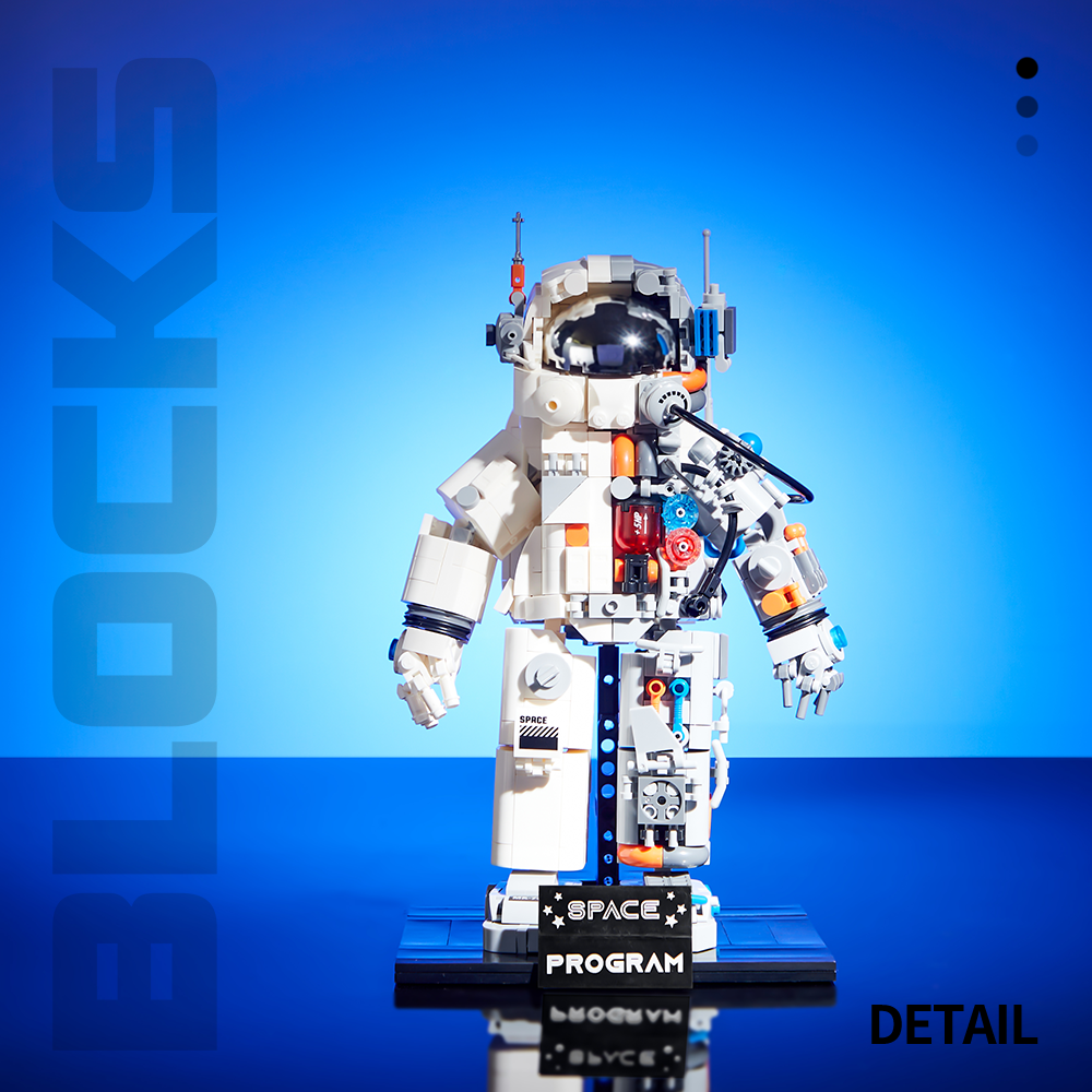 Front view of the assembled white mechanical astronaut standing on its display base.